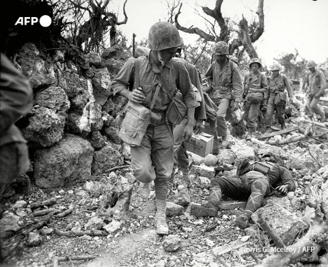 US Marines pass dead Japanese soldiers in a Okinawa village in April 1945 - AFP